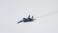 This file photo taken on January 1, 2023 shows a MIG-29 Ukrainian fighter jet flying over eastern Ukraine. - Slovakia will donate 13 MiG-29 warplanes to Ukraine, the Slovak prime minister said on March 17, 2023, making it the second NATO member to announce such a shipment following a similar move by Poland. (Photo by Sameer Al-DOUMY / AFP)
 