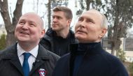 This handout photograph taken and released by the Russian presidential press office in Sevastopol on March 18, 2023, shows Russian President Vladimir Putin (R), talking to Sevastopol Governor Mikhail Razvozhayev (L), as he visits the Chersonesos Taurica historical and archeological park on the 9th anniversary of the referendum on the state status of Crimea and Sevastopol and its reunification with Russia. (Handout Photo / Russian Presidential Press Office / AFP) 