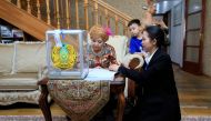 A woman votes at her home during parliamentary elections in Almaty on March 19, 2023.  (Photo by Ruslan PRYANIKOV / AFP)
