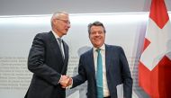 UBS Chairman Colm Kelleher (R) shakes hands with Credit Suisse chairman Axel Lehmann (L) after a press conference following talks over Credit Suisse in Bern on March 19, 2023.