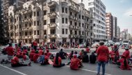 Members of the the Economic Freedom Fighters (EFF) stage a sit down on a street in Hillbrow, Johannesburg on March 20, 2023 during a 