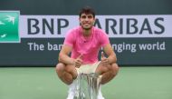 Carlos Alcaraz of Spain with the winners trophy after defeating Daniil Medvedev in the final during the BNP Paribas Open on March 19, 2023 in Indian Wells, California. Julian Finney/Getty Images/AFP