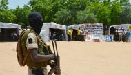 A soldier stands guard near information stands in a camp in Diffa, Niger. File photo / AFP