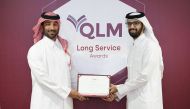 A QLM Life & Medical Insurance Company official presents long service award to an employee.