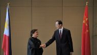Theresa Lazaro (left), Philippines' Undersecretary for Bilateral Relations and Asian Affairs of the Department of Foreign Affairs, shakes hands with China's Vice Foreign Minister Sun Weidong prior to the start of the Philippines-China Foreign Ministry consultation meeting in Manila on March 23, 2023. (Photo by Ted Aljibe / AFP)