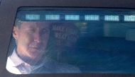 Former US President Donald Trump sits in the rear of his limousine as he leaves from Trump International Golf Club in Palm Beach, Florida, on March 23, 2023.  (Photo by CHANDAN KHANNA / AFP)