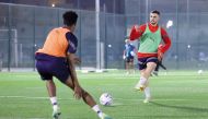 Al Duhail's Bassam Al Rawi with a teammate during a training session.