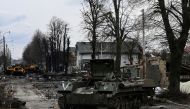 Destroyed Russian armored vehicles are pictured in the city of Bucha, west of Kyiv. (Photo by ARIS MESSINIS / AFP)
