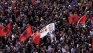 Kosovo Albanians wave Albanian flags and a flag depicting former Kosovo President Hashim Thaci as they take part in a march in Pristina on April 2, 2023. (Photo by Armend Nimani / AFP)


