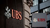 Signs of Swiss bank giant UBS bank are seen in Basel, on April 4, 2023 on the eve of the general meeting of shareholders following the takeover by UBS of Credit Suisse hastily arranged by the Swiss government on March 19, 2023 to prevent a financial meltdown. (Photo by Fabrice COFFRINI / AFP)