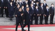 China's President Xi Jinping (C) and his French counterpart Emmanuel Macron arrive for the official welcoming ceremony in Beijing on April 6, 2023. (Photo by Ludovic Marin / AFP)