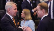 Finland Minister for Foreign Affairs Pekka Haavisto (left) and Sweden's Foreign Minister Tobias Billstroem (right) speak prior to attending a round table during the North Atlantic Council (NAC) Ministers of Foreign Affairs meeting at the NATO headquarters in Brussels on April 5, 2023. (Photo by Olivier Matthys / POOL / AFP)