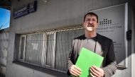 Liberal Democratic Party of Russia activist Viktor Bout, who was serving a 25-year sentence in a US prison and was exchanged in Abu Dhabi for American basketball star Brittney Griner in December, stands next to a telegraf office holding a telegram for former US president Donald Trump to share his prison experience during a symbolic action in Moscow on April 7, 2023.(Photo by Alexander Nemenov / AFP)