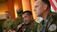 Philippines exercise director for Balikatan Major General Marvin Licudine (L) speaks while US exercise director and representative for Balikatan US marines Major General Eric Austin (R) listens during a press conference after the opening ceremony of the 'Balikatan' joint military exercise at the military headquarters in Quezon City, suburban Manila on April 11, 2023. (Photo by Ted ALJIBE / AFP)