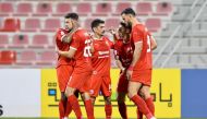 Al Arabi's Youssef Msakni (second left) celebrates with team-mates after scoring a goal yesterday.  