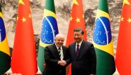 Chinese President Xi Jinping (right) and Brazil's President Luiz Inacio Lula da Silva shake hands after a signing ceremony at the Great Hall of the People in Beijing on April 14, 2023. (Photo by Ken Ishii / POOL / AFP)
