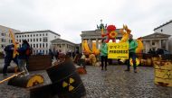 Activists of environmental organisation Greenpeace pose with a placard reading 'Progress' during a demonstration in front of the capital's landmark Brandenburg Gate in Berlin on April 15, 2023(Photo by Odd Andersen / AFP)
 