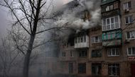 Firefighters work at a site of a burning residential building, after shelling in Sloviansk, on April 14, 2023.  Photo by ANATOLII STEPANOV / AFP

