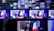A photo of monitors in a media control room shows French President Emmanuel Macron during a televised address to the nation, made from the Elysee Palace, after signing into law a pensions reform, in Paris, on April 17, 2023. (Photo by Ludovic MARIN / AFP)
 