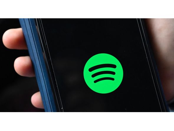This file illustration photo taken on January 23, 2023 shows the company logo of Swedish music streaming giant Spotify on a smartphone in Berlin. Photo by Tobias Schwarz / AFP