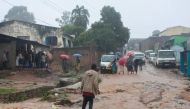 File photo: Residents walk in a street following heavy rains after cyclone Freddy made landfall in Mozambique and Malawi killing over 100 people.(Photo by Amos Gumulira / AFP)