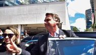 Former Brazilian President Jair Bolsonaro gestures while leaving the Federal Police headquarters after testifying in Brasilia on April 26, 2023. (Photo by TON MOLINA / AFP)