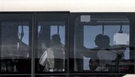 Civilians evacuated from Sudan via a British Royal Air Force plane ride a bus to the terminal at Larnaca International Airport in Cyprus on April 26, 2023. Photo by Christina ASSI / AFP