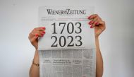 A woman holds the current issue of the 