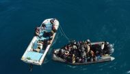 An aerial picture shows boats transporting migrants of different nationalities entering a port in the Garabulli area following their rescue at sea by the Libyan Coast Guard, on April 25, 2023. (Photo by Mahmud Turkia / AFP)