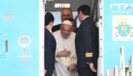Pope Francis waves bords the plane following the farewell ceremony at Budapest International Airport on April 30, 2023 as his second visit to Hungary in less than two years comes to an end. (Photo by Attila KISBENEDEK / AFP)