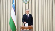 A handout photograph released by the Press Service of the President of Uzbekistan on April 30, 2023, shows Uzbek President Shavkat Mirziyoyev casting his vote at a polling station in Tashkent. (Photo by Handout / Uzbek Presidential Press Service / AFP) 