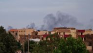 Smoke billows over residential buildings in Khartoum on April 30, 2023 as deadly clashes between rival generals' forces have entered their third week.(Photo by AFP)