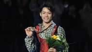 This file photo taken on March 25, 2010 shows gold medallist Japan's Daisuke Takahashi posing with his medal as he celebrates on the podium after winning the men's competition at the World Figure Skating Championships at the Palavela ice-rink in Turin. Photo by Yuri KADOBNOV / AFP
