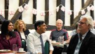 Britain's Prime Minister Rishi Sunak (C) and Britain's Home Secretary Suella Braverman (L) visit a U3A community group at the Chiltern leisure centre in Amersham, England, on May 3, 2023. (Photo by Frank Augstein / POOL / AFP)