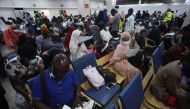 A view of fleeing Nigerian students in Sudan filling their arrival form after being evacuated from Sudan to Nigeria at the Nnamdi Azikwe International Airport in Abuja, Nigeria on May 4, 2023. (Photo by KOLA SULAIMON / AFP)