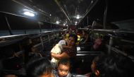 People arrive by bus to a shelter in a sports center after fleeing from their village affected by Fuego volcano in Santa Lucia Cotzumalguapa, Escuintla south of Guatemala City, on May 4, 2023. Photo by Johan ORDONEZ / AFP