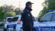 A policeman is seen in the village of Dubona near the town of Mladenovac, about 60 kilometres (37 miles) south of Serbia's capital Belgrade, on May 05, 2023, in the aftermath of a drive-by shooting. Photo by ANDREJ ISAKOVIC / AFP