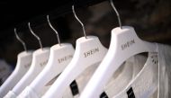 Clothes are displayed on hangers at a Chinese fashion brand Shein pop-up store in Paris on May 4, 2023. (Photo by Christophe Archambault / AFP)