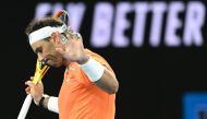Spain's Rafael Nadal reacts as he plays against USA's Mackenzie McDonald during their men's singles match on day three of the Australian Open tennis tournament in Melbourne on January 18, 2023. (Photo by MANAN VATSYAYANA / AFP)
