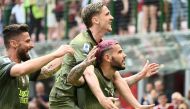 AC Milan's French defender Theo Hernandez (R) celebrates with AC Milan's Belgian forward Alexis Saelemaekers (C) and AC Milan's French forward Olivier Giroud after scoring his side's second goal during the Italian Serie A football match between AC Milan and Lazio on May 6, 2023 at the San Siro stadium in Milan. (Photo by Isabella BONOTTO / AFP)
