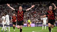 Manchester City's Belgian midfielder Kevin De Bruyne (L) next to Manchester City's Norwegian striker Erling Haaland celebrates scoring his team's first goal during the UEFA Champions League semi-final first leg football match between Real Madrid CF and Manchester City at the Santiago Bernarr stadium in Madrid on May 9, 2023. (Photo by JAVIER SORIANO / AFP)
