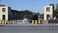 Policemen stand guard at the main entrance of the Pakistan's army headquaters in Rawalpindi on May 10, 2023. (Photo by Aamir Qureshi / AFP)