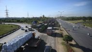 Trucks are seen stuck along a highway blocked during an ongoing protest in Islamabad on May 11, 2023. (Photo by Aamir Qureshi / AFP)