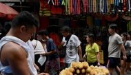 A vendor waits for customers along a street in Manila on May 11, 2023. (Photo by Jam Sta Rosa / AFP)
 