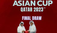 Qatar Football Association’s President Sheikh Hamad bin Khalifa bin Ahmed Al Thani (left) and President of the Asian Football Confederation (AFC) Shaikh Salman bin Ebrahim Al Khalifa pose for a picture during the draw for the AFC Asian Cup in Doha yesterday. (AFP)