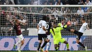 Spezia's Polish defender Przemyslaw Wisniewski (R) scores his team's first goal during the Italian Serie A football match between Spezia and AC Milan at the Alberto-Picco stadium in La Spezia, on May 13, 2023. (Photo by Vincenzo PINTO / AFP)
