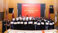 The successful students with their certificates of completion during a ceremony.
