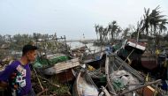 A local resident looks at broken boats in Sittwe, in Myanmar's Rakhine state, on May 15, 2023, after cyclone Mocha made a landfall. (Photo by Sai Aung Main / AFP)