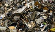 A pile of waste of mattresses, clothes and furniture coming from flooded homes is pictured on May 19, 2023 in Faenza, after floodwaters hit the Emilia-Romagna region. (Photo by Andreas Solaro / AFP)