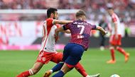 Bayern Munich's Moroccan defender Noussair Mazraoui (L) and Leipzig's Spanish midfielder Dani Olmo vie for the ball during the German first division Bundesliga football match between FC Bayern Munich and RB Leipzig in Munich, southern Germany, on May 20, 2023. (Photo by Christof STACHE / AFP)